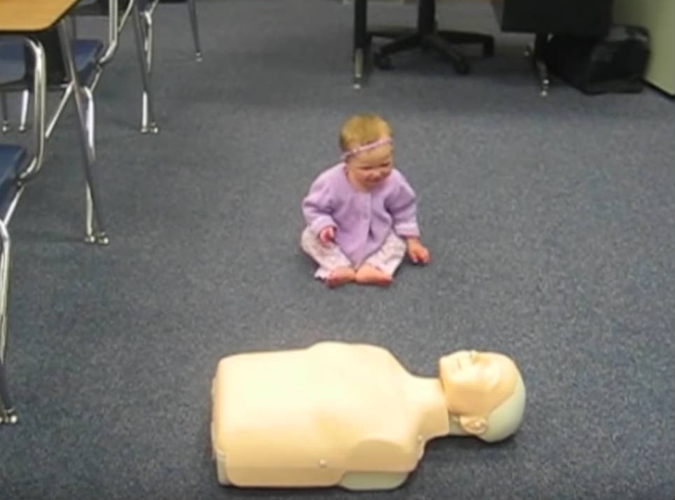 Baby Girl Spots A CPR Dummy Needing Help And She Steps Up And “Saves” A